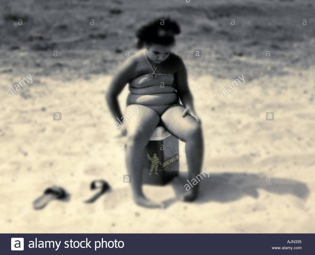 overweight-girl-sitting-on-bottle-cooler-looking-sad-AJN335.jpg